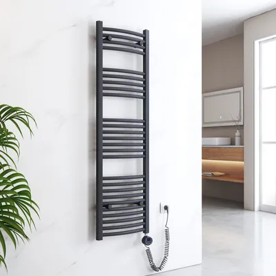 A dark gray electric towel radiator mounted on a white marble wall in a modern bathroom.