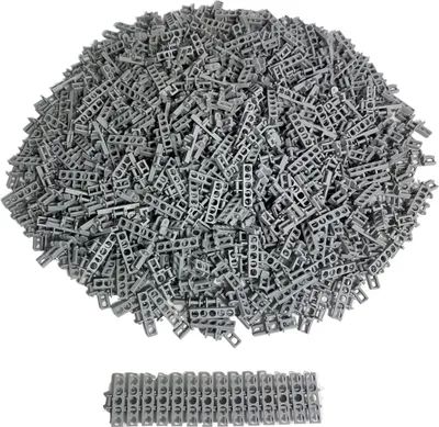 A pile of small, gray, interlocking plastic pieces, likely LEGO Technic chain links, with a small row of them neatly arranged in the foreground.