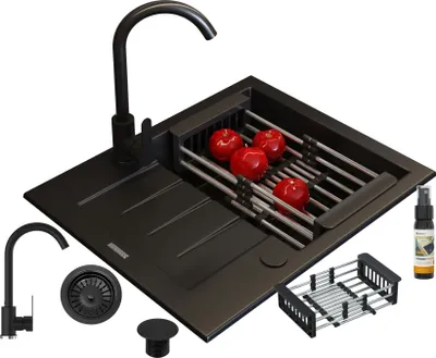 A black granite kitchen sink with a faucet, drainer, and accessories, including apples, is displayed against a white background.