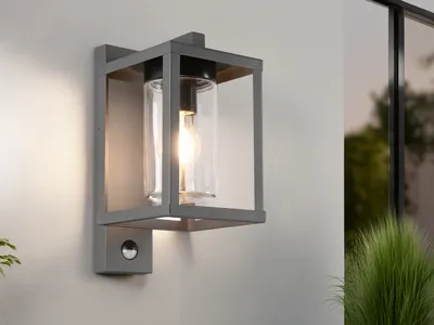 An outdoor wall light mounted on a light gray wall.