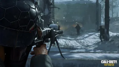 A soldier in a helmet aims a machine gun in a snowy environment, with other soldiers in the background.