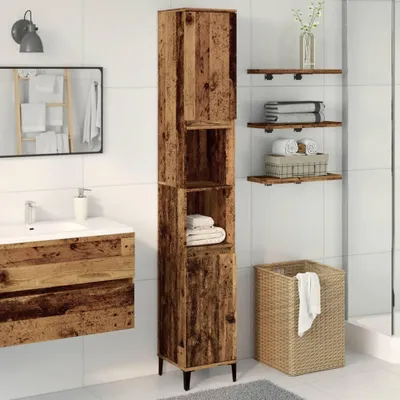 A bathroom with a tall wooden cabinet, a sink vanity, shelves, and a laundry basket.