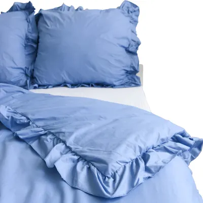 A close-up view of a blue bedding set with ruffles.