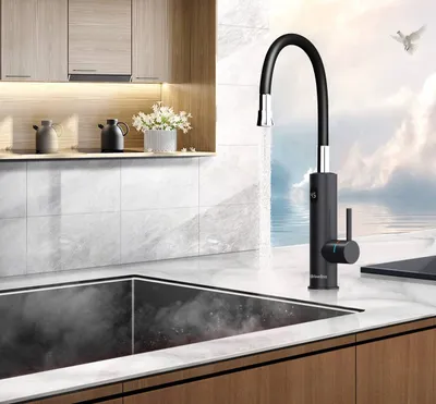 A modern kitchen sink area with a black faucet and a steaming sink, set against a backdrop of a serene ocean and sky.