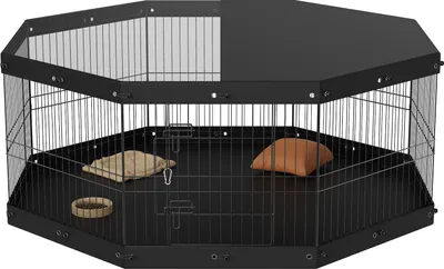 A black octagonal pet playpen with a solid top and bottom, containing two small cushions and a ring toy.