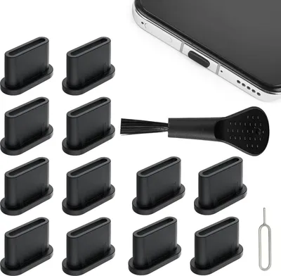 A collection of USB-C dust plugs, a cleaning brush, and a SIM card ejector tool arranged on a white background, with a partial view of a smartphone in the upper right corner.