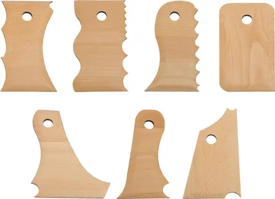 A collection of wooden pottery shaping tools arranged on a white background.