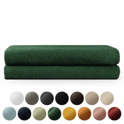 Two folded dark green towels are stacked on top of each other, with a row of color swatches below them.