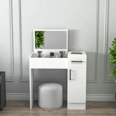 A white vanity table with a mirror and a stool in a room with light gray walls.