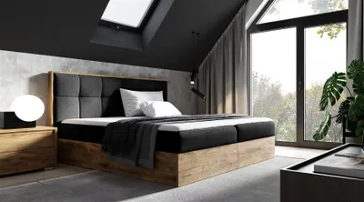 A modern bedroom with a large bed, large window, and skylight.