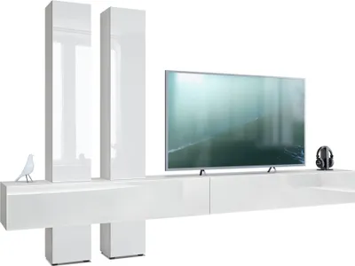 A modern white TV stand with two tall vertical cabinets and a television on top.