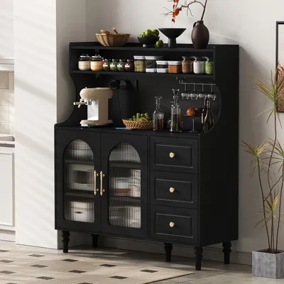 A black kitchen cabinet with glass doors and drawers, displaying various kitchen items and decorative elements.