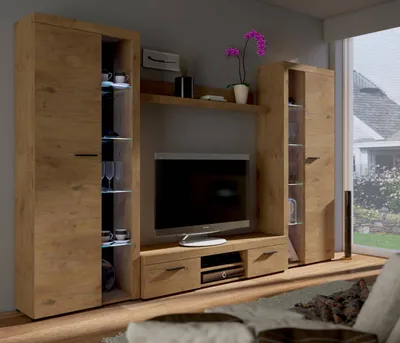 A living room entertainment center with a TV and storage cabinets.