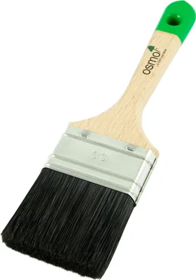 A paintbrush with black bristles and a wooden handle with a green end.