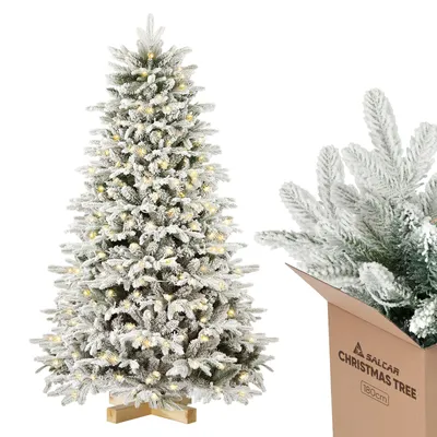 A flocked artificial Christmas tree with lights and a close-up of branches in a box.