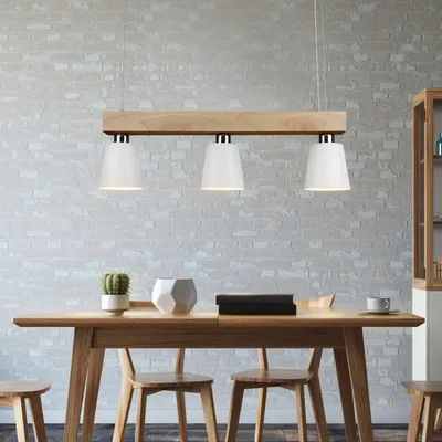 A dining table with chairs and a pendant light fixture above.