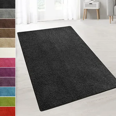 A dark gray shaggy rug is displayed on a light-colored floor in a room with white curtains and a white side table. A strip of color swatches is visible on the left side of the image.
