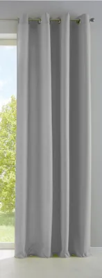 A set of gray curtains hanging in front of a window with trees visible outside.
