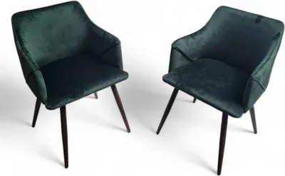 Two green upholstered chairs with dark wooden legs are shown against a white background.