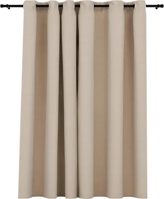 A close-up view of beige curtains hanging from a black curtain rod.