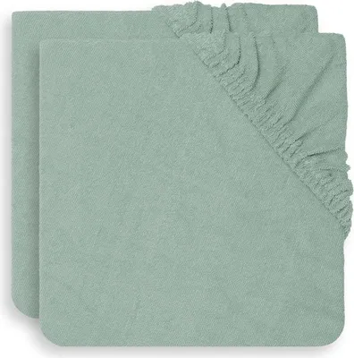 Two folded green fitted sheets are shown from a top-down perspective.