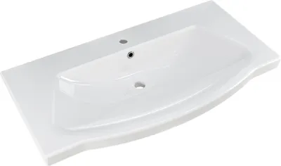 A white ceramic sink with a wide, flat countertop.