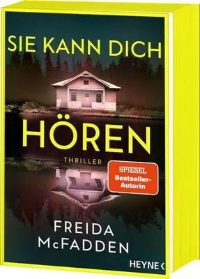 A book cover with a house reflected in water.