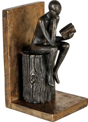 Produktbild von Casablanca Buchstütze "Human" Poly . goldfarben . Antikfinish . schwarz gewischt lesende Figur auf Holzstamm H= 20 cm B= 9 cm T= 11cm 89212