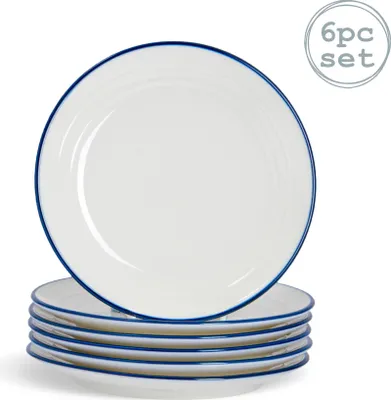 A stack of white dessert plates with blue rims, with one plate slightly offset on top.