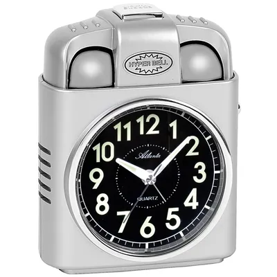 A silver alarm clock with a black face and white numbers.