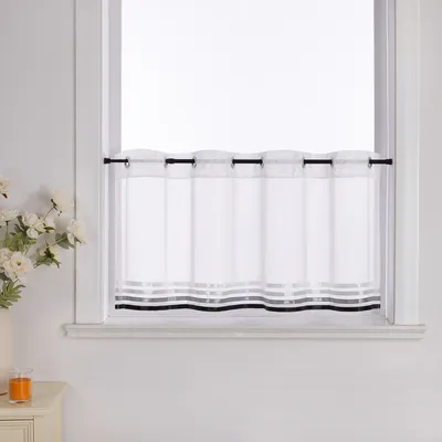 A white sheer curtain with horizontal gray and black stripes at the bottom, hanging in a window.