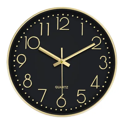 A black analog wall clock with gold numbers and hands, set against a white background.