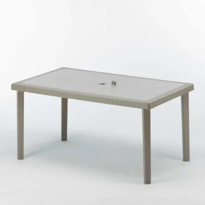 A rectangular outdoor dining table with a woven rattan base and a glass top, shown against a white background.