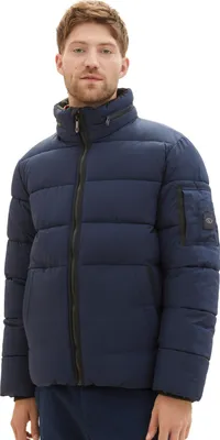 A man wearing a blue puffer jacket.