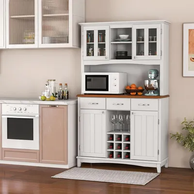 A kitchen scene featuring a white buffet cabinet with a wine rack and drawers, a microwave, and an oven.