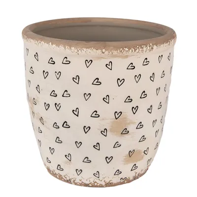 A beige ceramic pot with black heart designs.