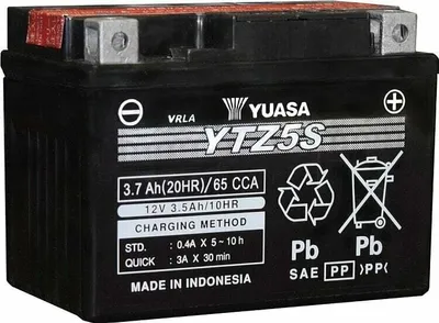 A black motorcycle battery with labels and specifications.