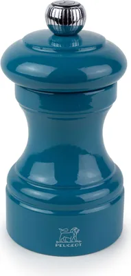 A teal-colored Peugeot pepper mill on a white background.