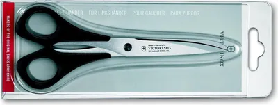 A pair of black-handled scissors for left-handed users, packaged in a clear plastic blister pack with a cardboard backing.