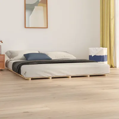 A minimalist bedroom scene featuring a low-profile wooden bed frame with a mattress and bedding, a nightstand, and a laundry basket.