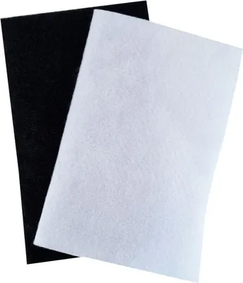 Two sheets of material, one black and one white, are overlapped on a white background.