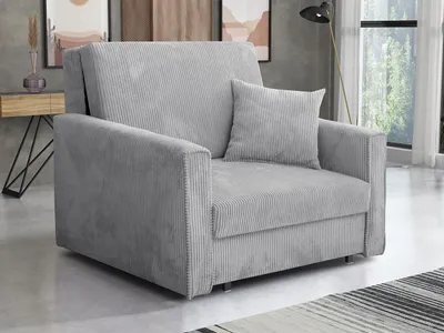 A light gray corduroy sofa is shown in a room with a wooden side table and artwork in the background.