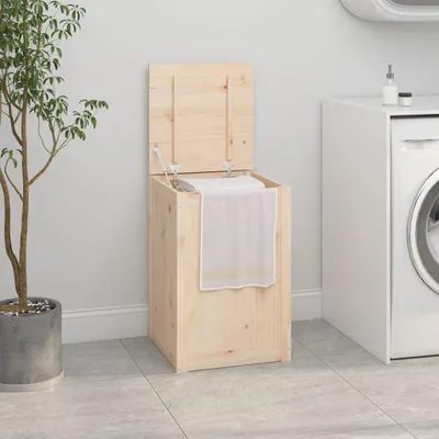 A wooden laundry hamper with its lid open, placed next to a potted plant and a washing machine in a laundry room.