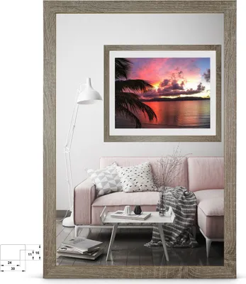 A living room scene with a pink sofa, a coffee table, and a mirror reflecting a tropical sunset.