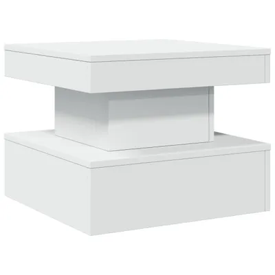 A modern white coffee table with a stacked, geometric design.