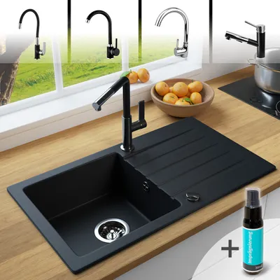 A black granite kitchen sink with a faucet and a bowl of fruit on a wooden countertop, with other faucets in the background.
