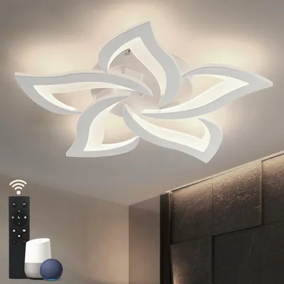A modern bedroom with a flower-shaped ceiling light and smart home devices.