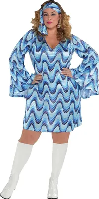 A woman wearing a disco costume and white boots, posing against a white background.