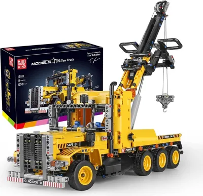 A yellow toy tow truck with a crane is displayed next to its packaging box.