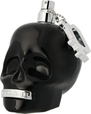 A black skull-shaped perfume bottle with a silver spray nozzle and a silver tag attached by a chain.